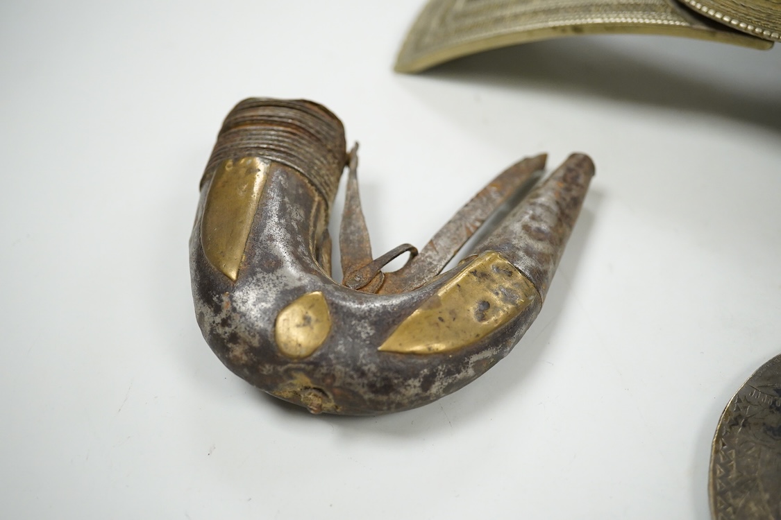 A niello work belt buckle, 21cm wide, an Arab white metal cloak brooch and a powder flask